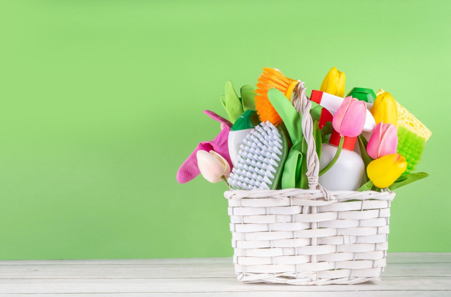 Spring basket with flowers and cleaning supplies