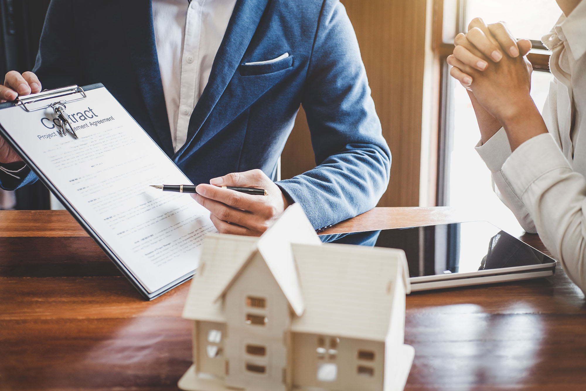 Realtor and new homeowner reviewing paperwork excitedly.