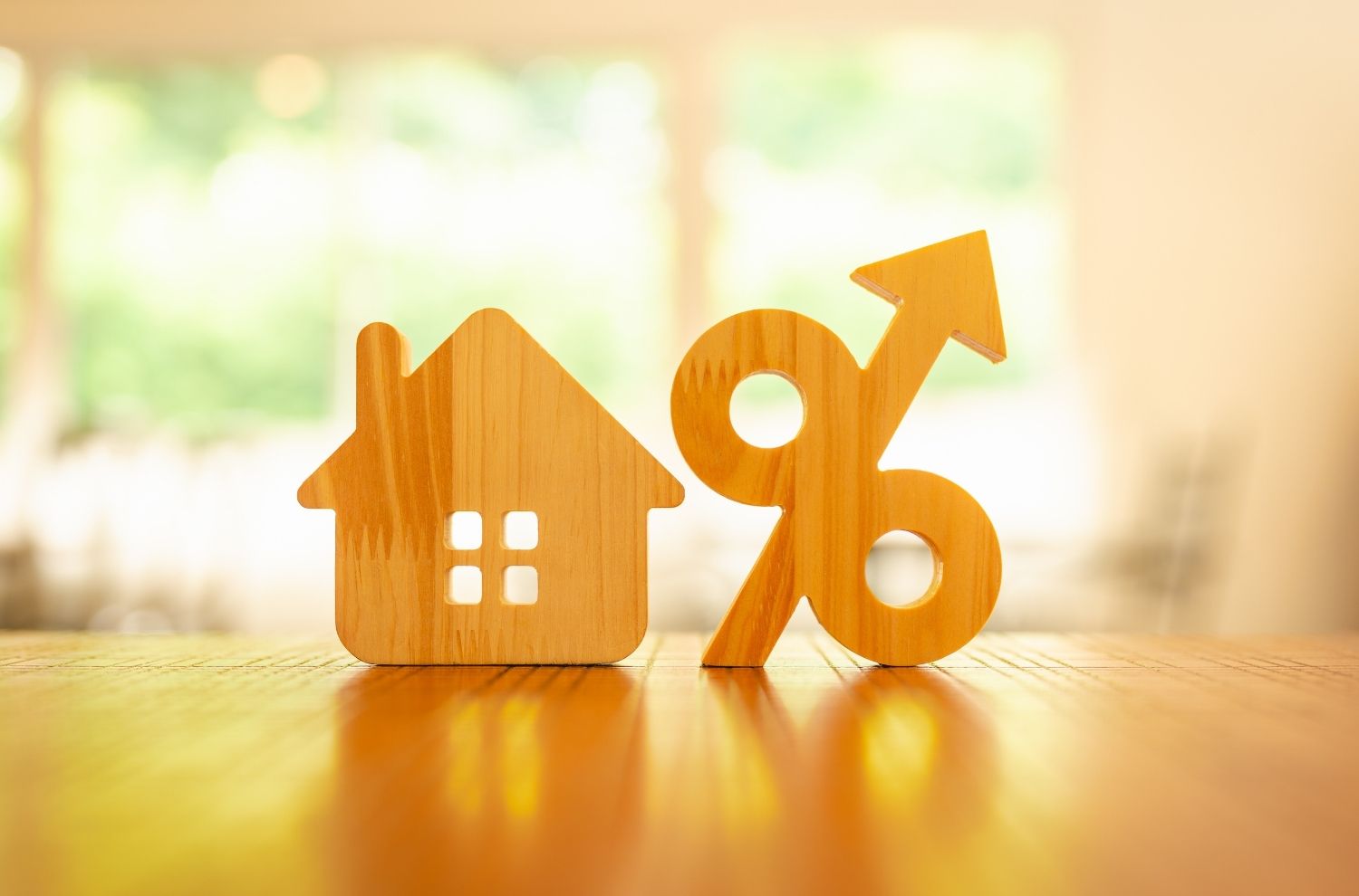 House and percentage sign wooden blocks sitting together on table