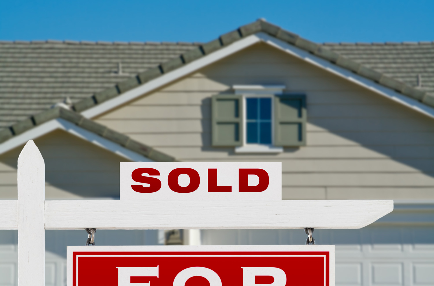 Real estate sold sign outside of house