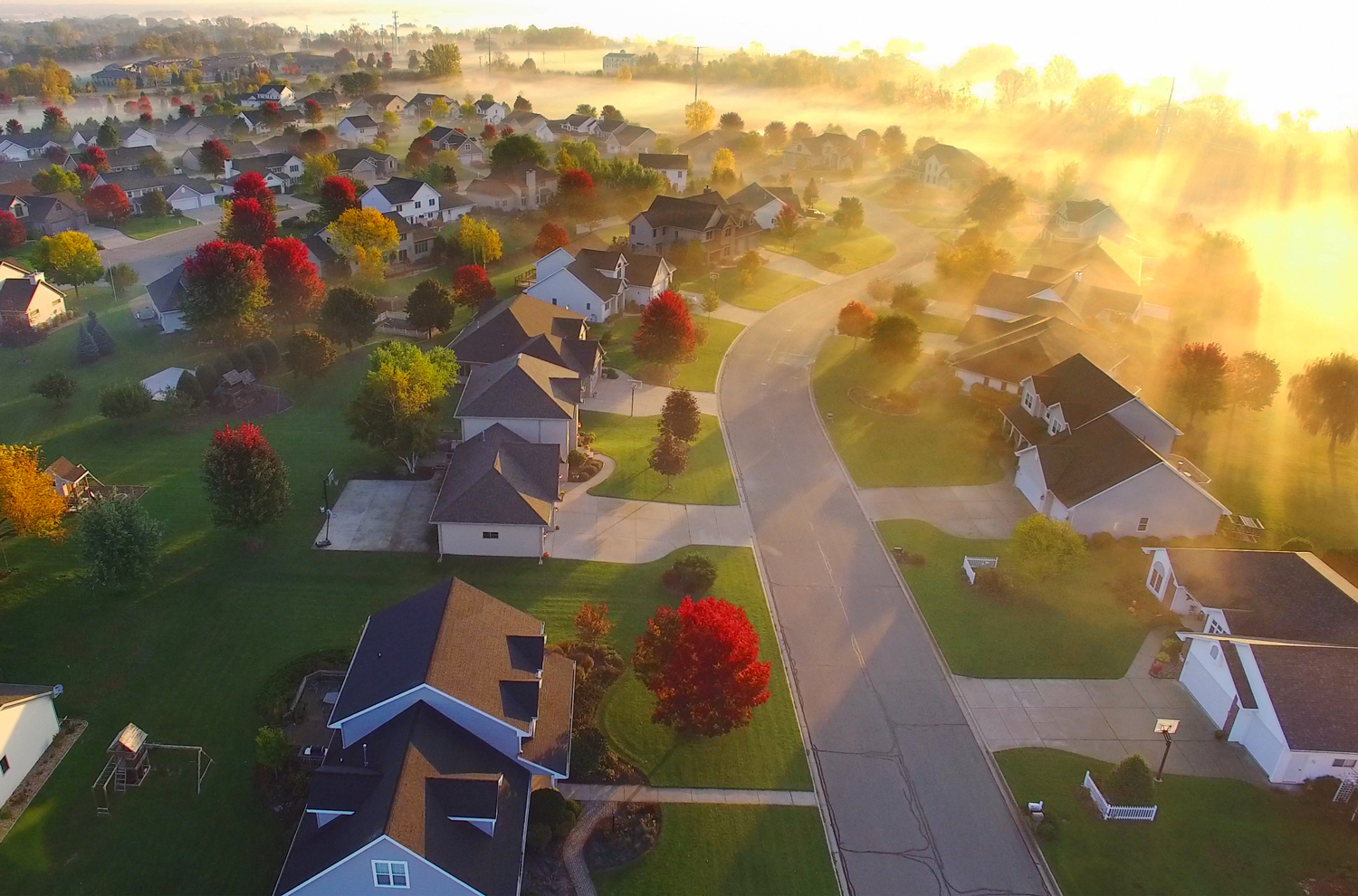 Aerial view of suburban subdivision with fall colors on trees