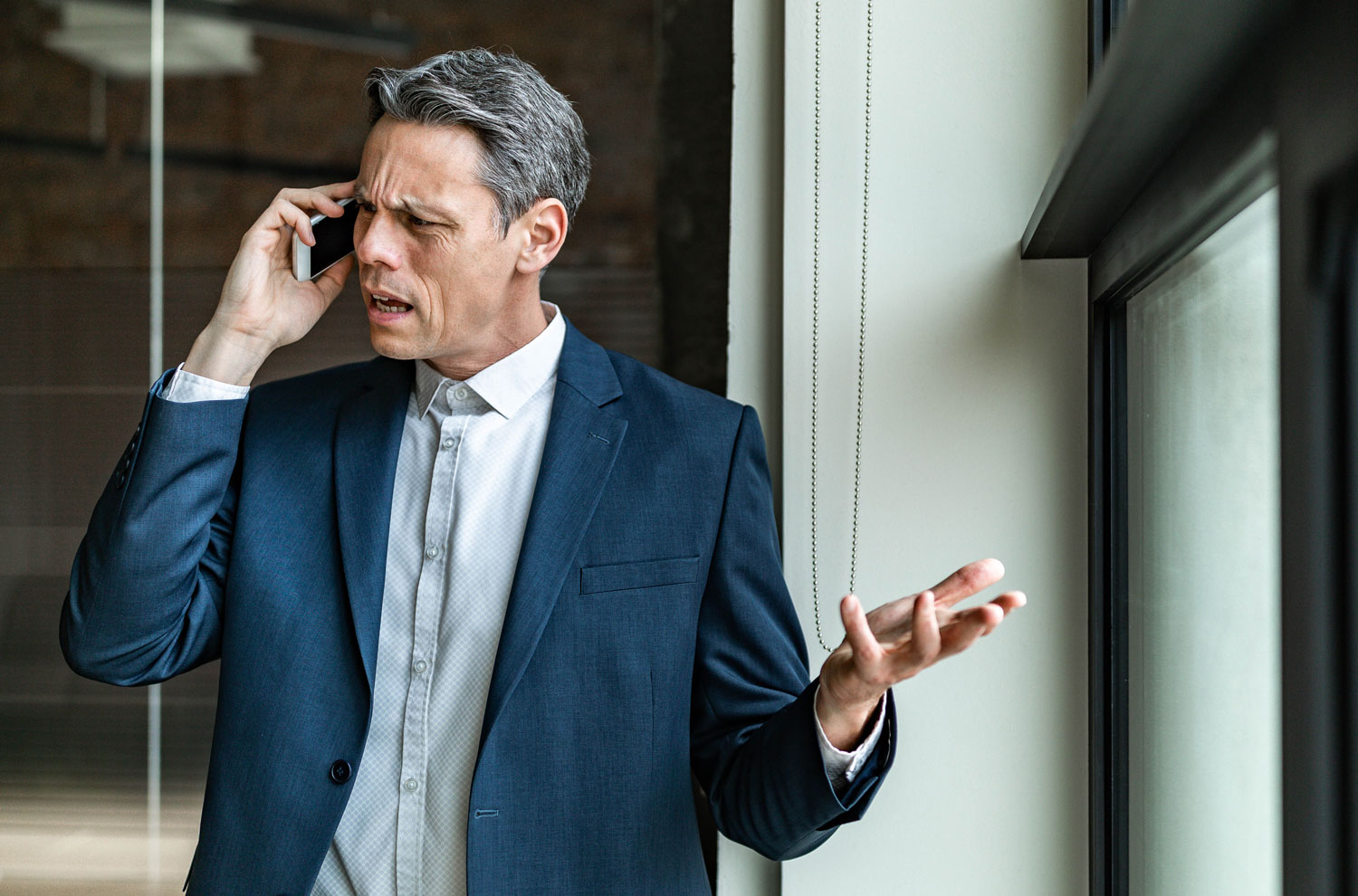 Businessman looking agitated during call on smartphone