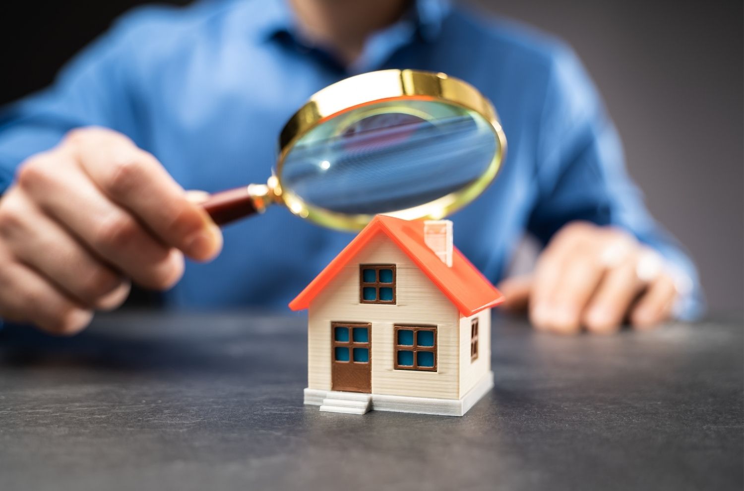 Model home underneath magnifying glass