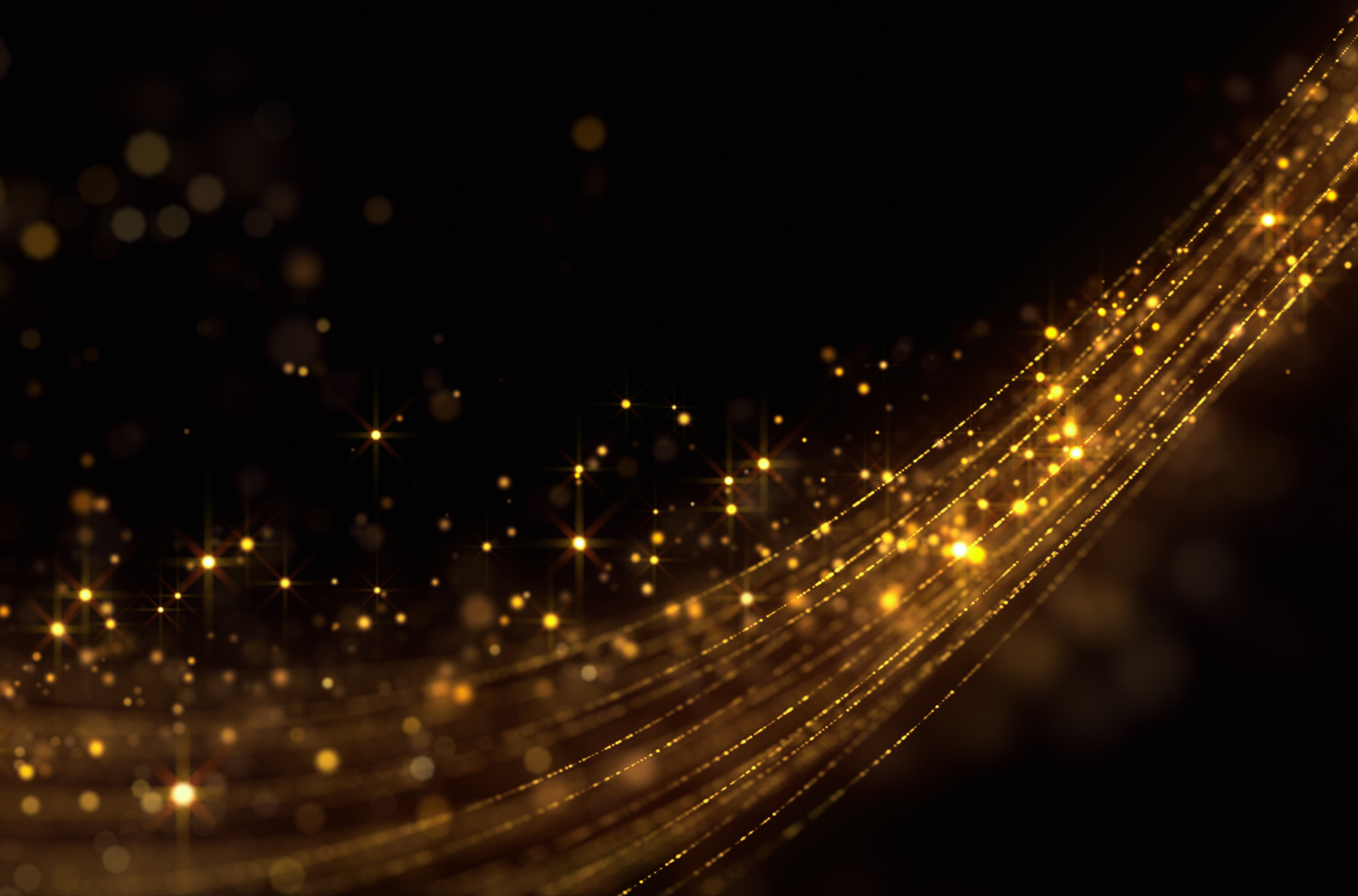 Gold glitter and streamers against black background