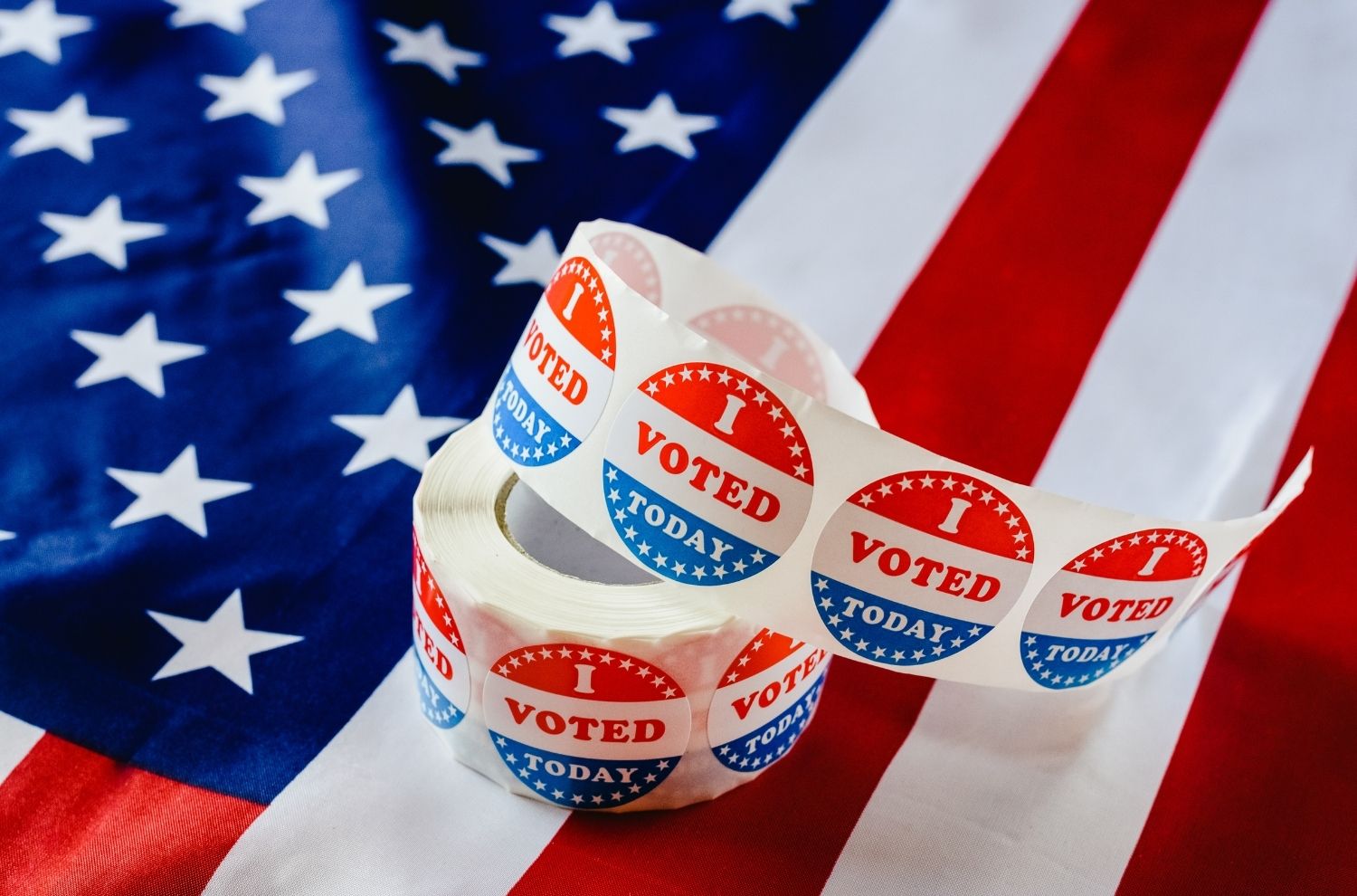 Roll of "I voted" stickers sitting on American flag