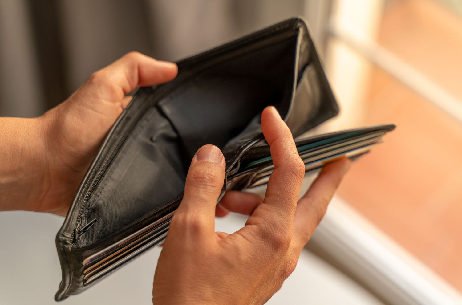 Closeup of male hands folding open an empty wallet
